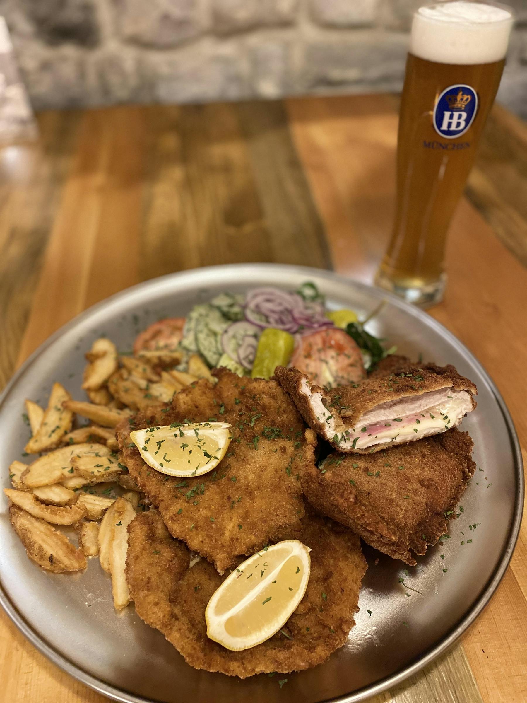 a plate of food and a cup of beer